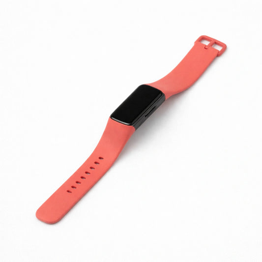 Original red silicone band compatible with Fitbit Charge 5 on a clean background