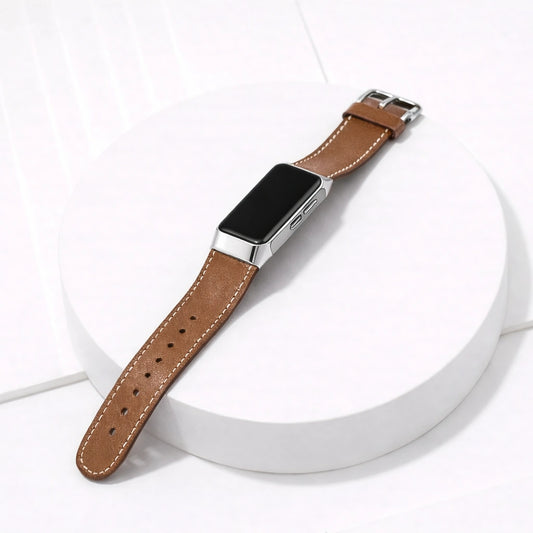 Brown leather strap for Fitbit Charge 5 shown on a clean flatlay display