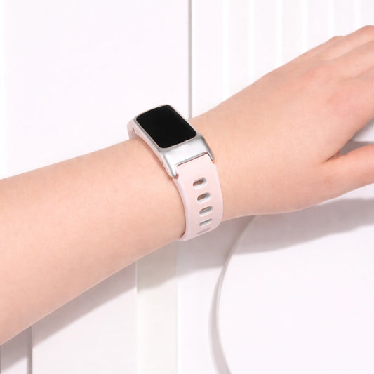 Light pink and white sports strap for Fitbit Charge 5 worn on wrist showing soft colour and comfortable fit
