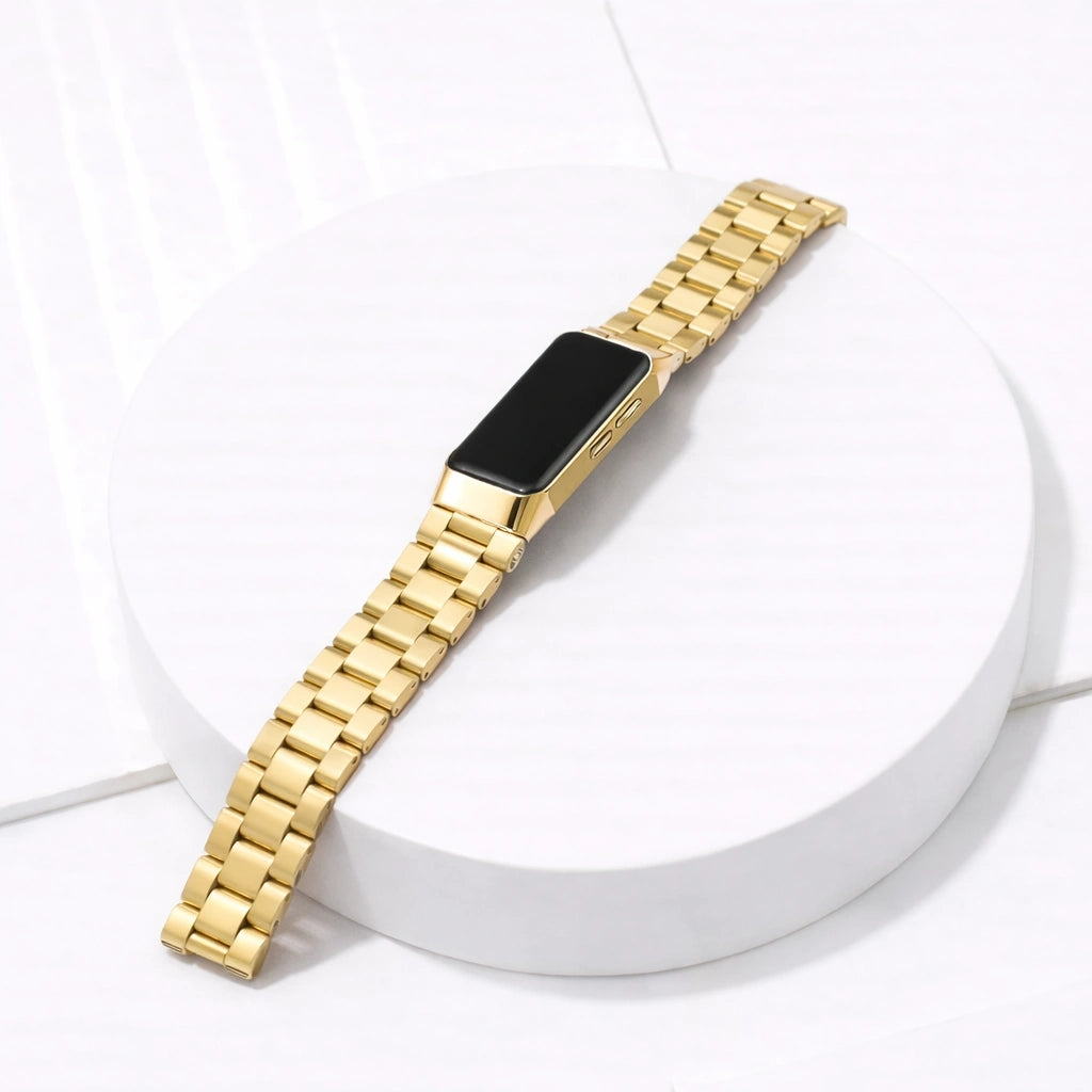 Fitbit Charge 5 gold metal watch strap with stainless steel links on white platform