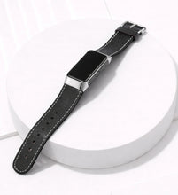 Black leather replacement watch strap for Fitbit Charge 6 shown laying flat