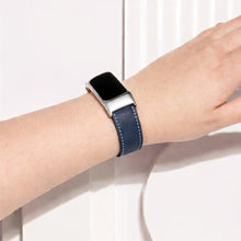 Blue leather Fitbit Charge 6 strap worn on the wrist