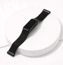 Metallic black mesh strap for Fitbit Charge 6 shown laying flat on a white surface