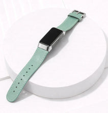 Mint leather wristband for Fitbit Charge 6 displayed in a flat lay with silver buckle