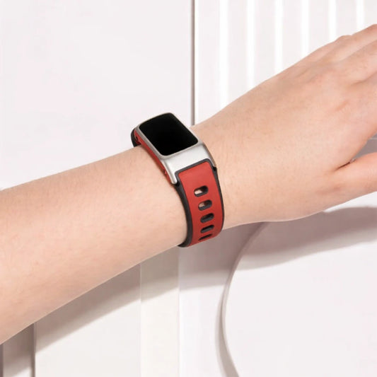 Fitbit Charge 6 worn with a red and black sports style strap on the wrist
