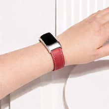 Red leather Fitbit Charge 6 band worn on the wrist