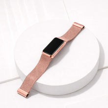 Rose gold metal strap for Fitbit Charge 6 shown laying flat on a white surface