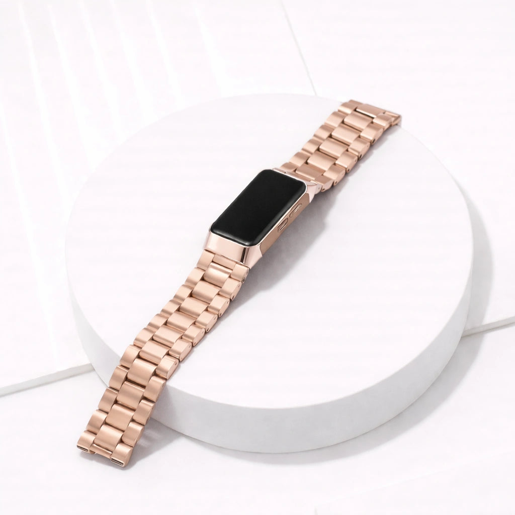 Rose gold stainless steel link band for Fitbit Charge 6 displayed in a clean flat lay setting