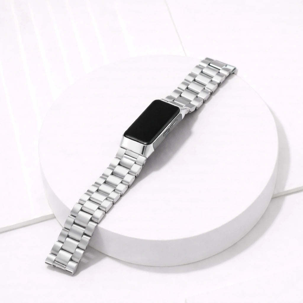 Silver stainless steel replacement link strap for Fitbit Charge 6 shown in a flat lay studio setting