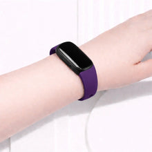Dark purple Fitbit Inspire 2 band worn on the wrist for everyday comfort