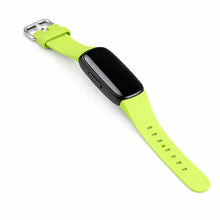 Green watch strap for Fitbit Inspire 2 shown with tracker attached