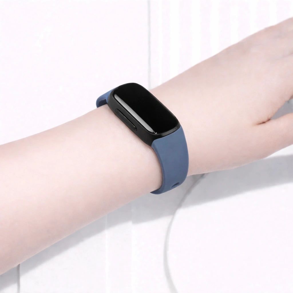 Grey Fitbit Inspire 2 band worn on the wrist for a neutral everyday look