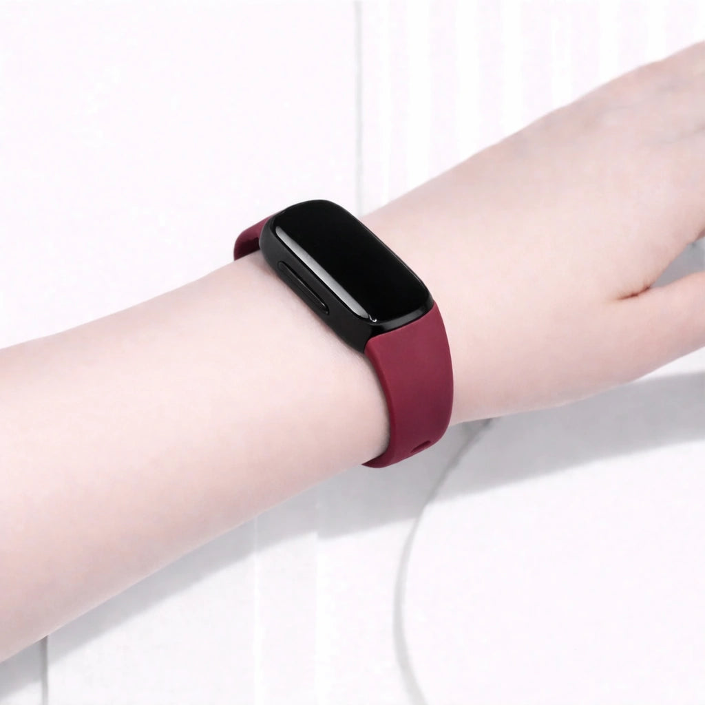 Red Fitbit Inspire 2 band worn on the wrist for a comfortable everyday fit
