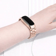 Rose gold metal strap for Fitbit Inspire 2 worn on the wrist