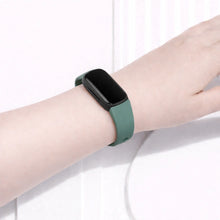 Green watch strap fitted to a Fitbit Inspire 3 during everyday wear