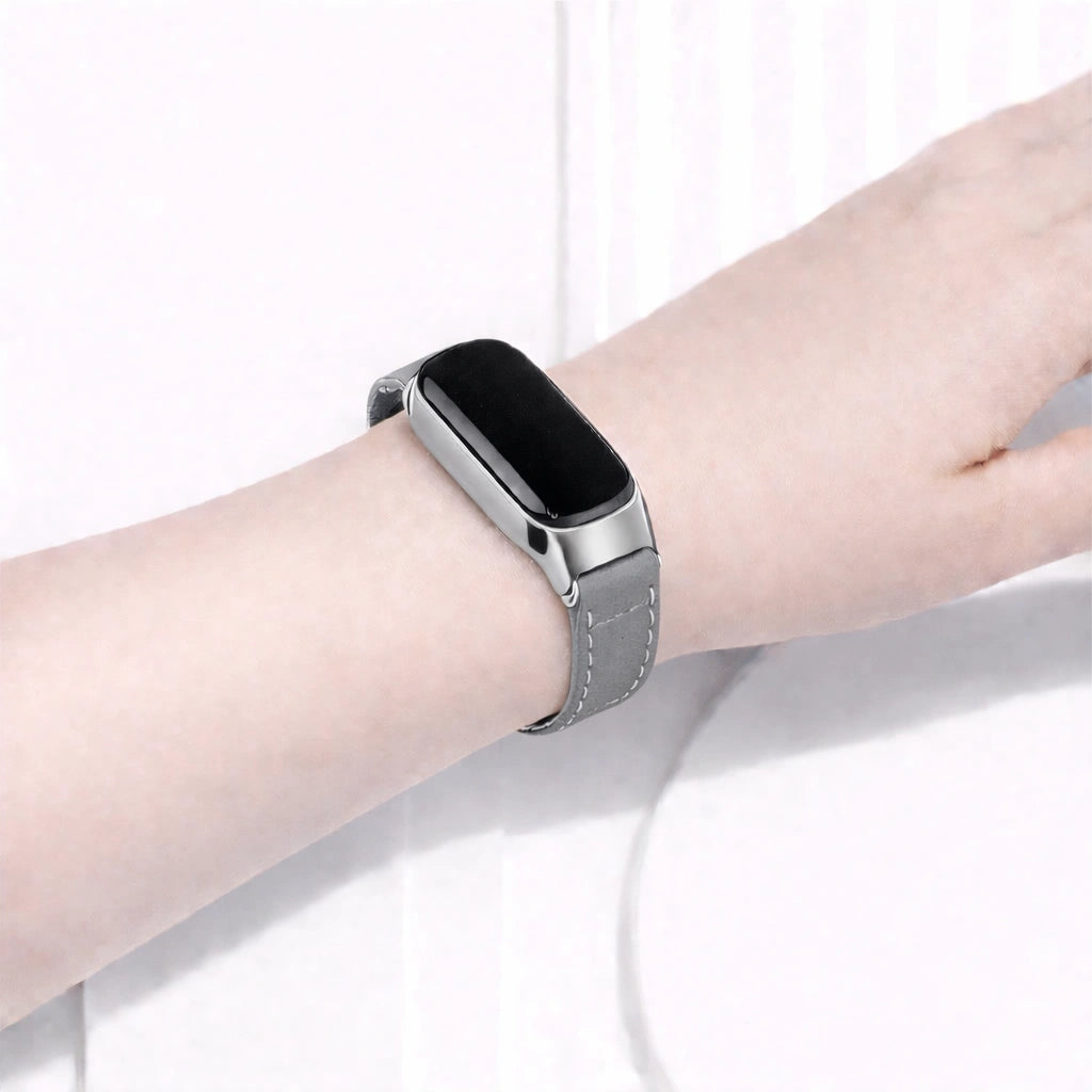 Grey leather watch strap worn on a Fitbit Inspire 3