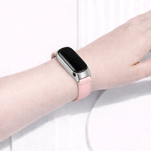 Pink leather wristband fitted to a Fitbit Inspire 3