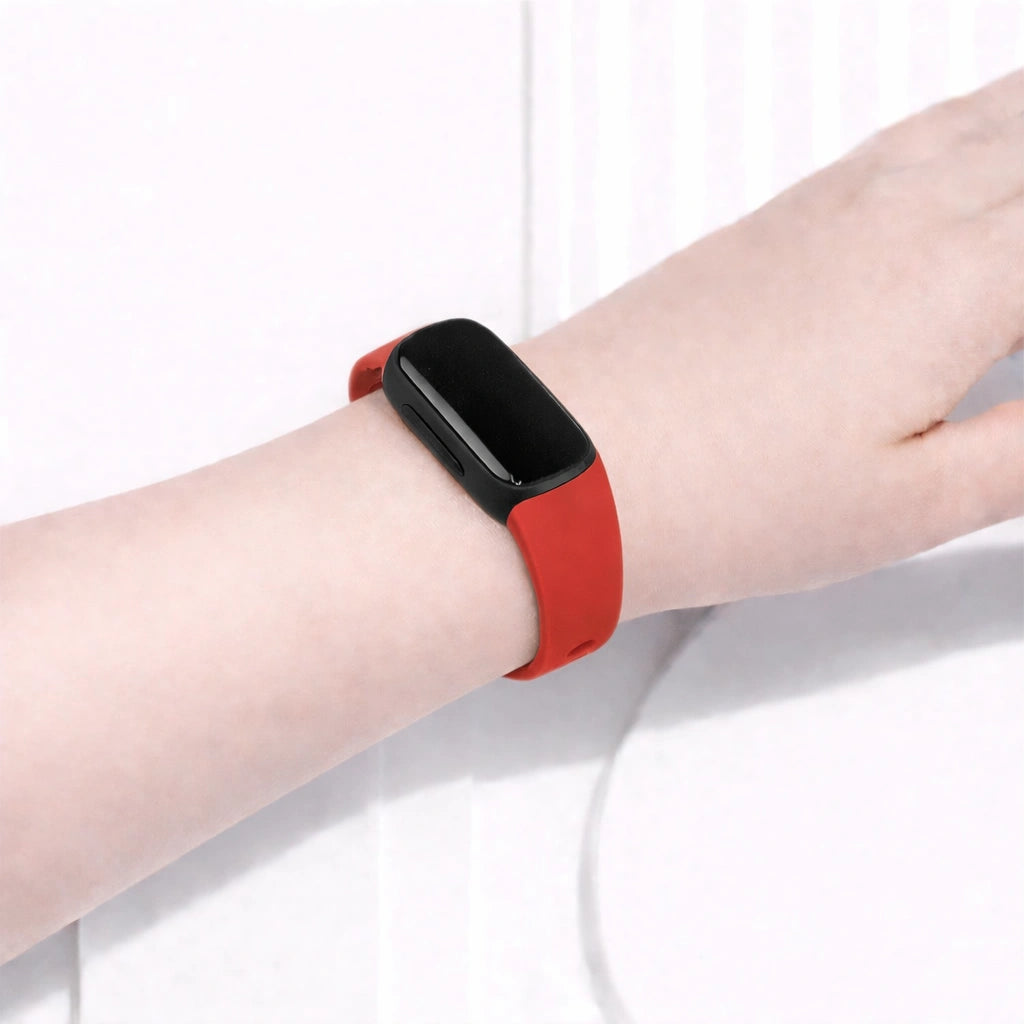 Red watch band worn on a Fitbit Inspire 3