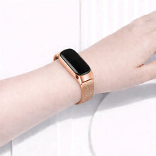 Rose gold Milanese watch band worn on a Fitbit Inspire 3