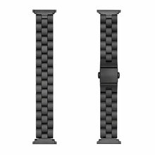 Black stainless steel link band for Fitbit Luxe shown in flatlay with clasp detail