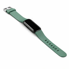 Green Fitbit Luxe band fitted to tracker with smooth matte finish and silver buckle