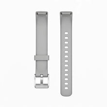 Light grey strap for Fitbit Luxe attached to black tracker with silver buckle