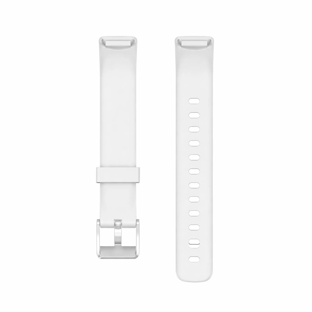 White silicone Fitbit Luxe straps shown in flat lay with silver buckle and adjustable strap holes
