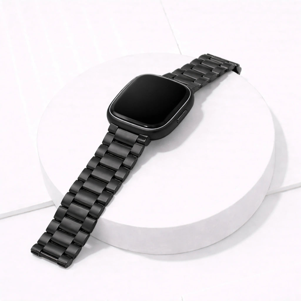 Black stainless steel watch strap for Fitbit Sense 2 displayed in a clean flat lay, featuring a durable metal link wristband