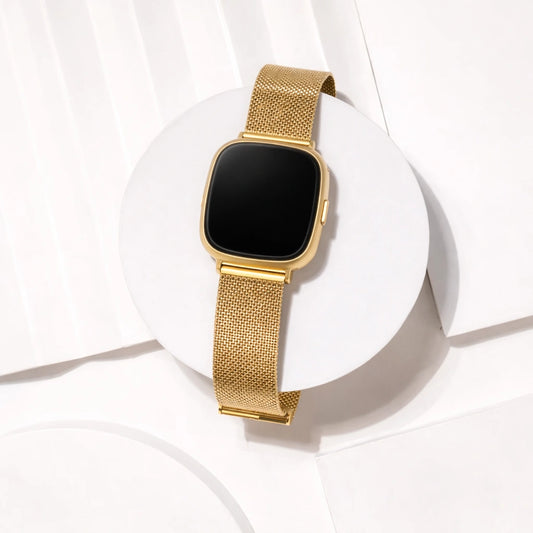 Gold Milanese mesh watch strap for Fitbit Sense 2 displayed in flat lay