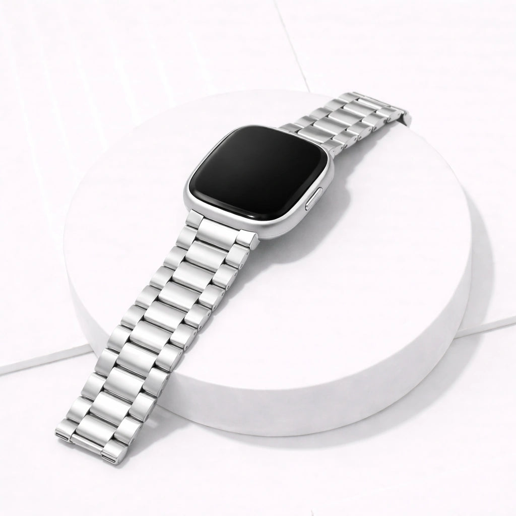 Silver metal link watch strap for Fitbit Sense 2 shown in a clean flat lay with brushed stainless steel finish