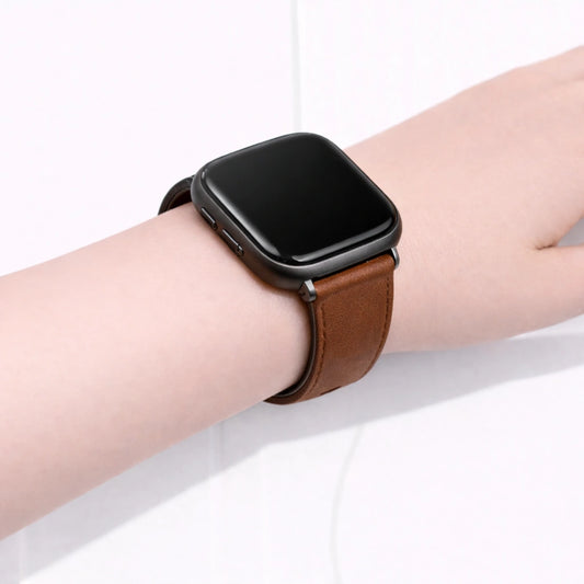 Close-up of a brown leather band on a Fitbit Versa 2, showing the slim fit and smooth leather finish.