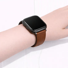 Close-up of a brown leather band on a Fitbit Versa 2, showing the slim fit and smooth leather finish.