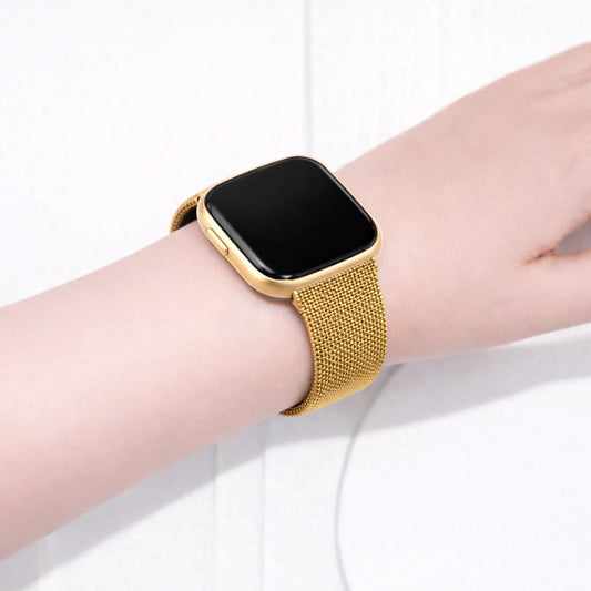 Gold metal mesh watch strap for Fitbit Versa 2 worn on the wrist with a smooth and secure fit