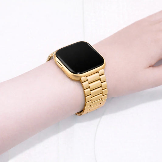 Gold metal strap on wrist fitted to a Fitbit Versa 2 smartwatch