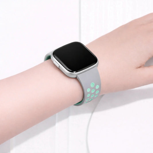 Fitbit Versa 2 sports band in grey and mint worn on the wrist for training and daily use
