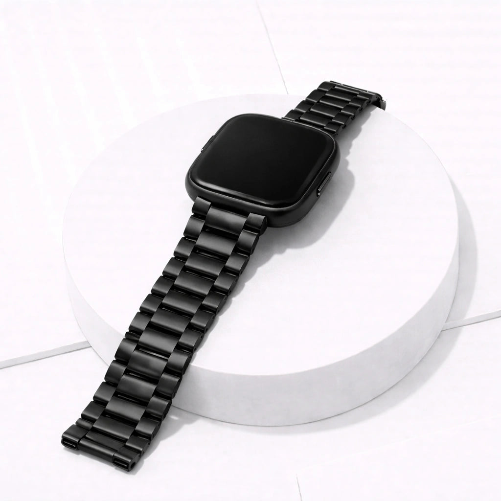 Metal black stainless steel strap for Fitbit Versa 2 displayed on a white stand