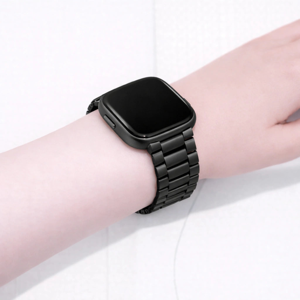 Metal black Fitbit Versa 2 strap worn on the wrist with a stainless steel link design