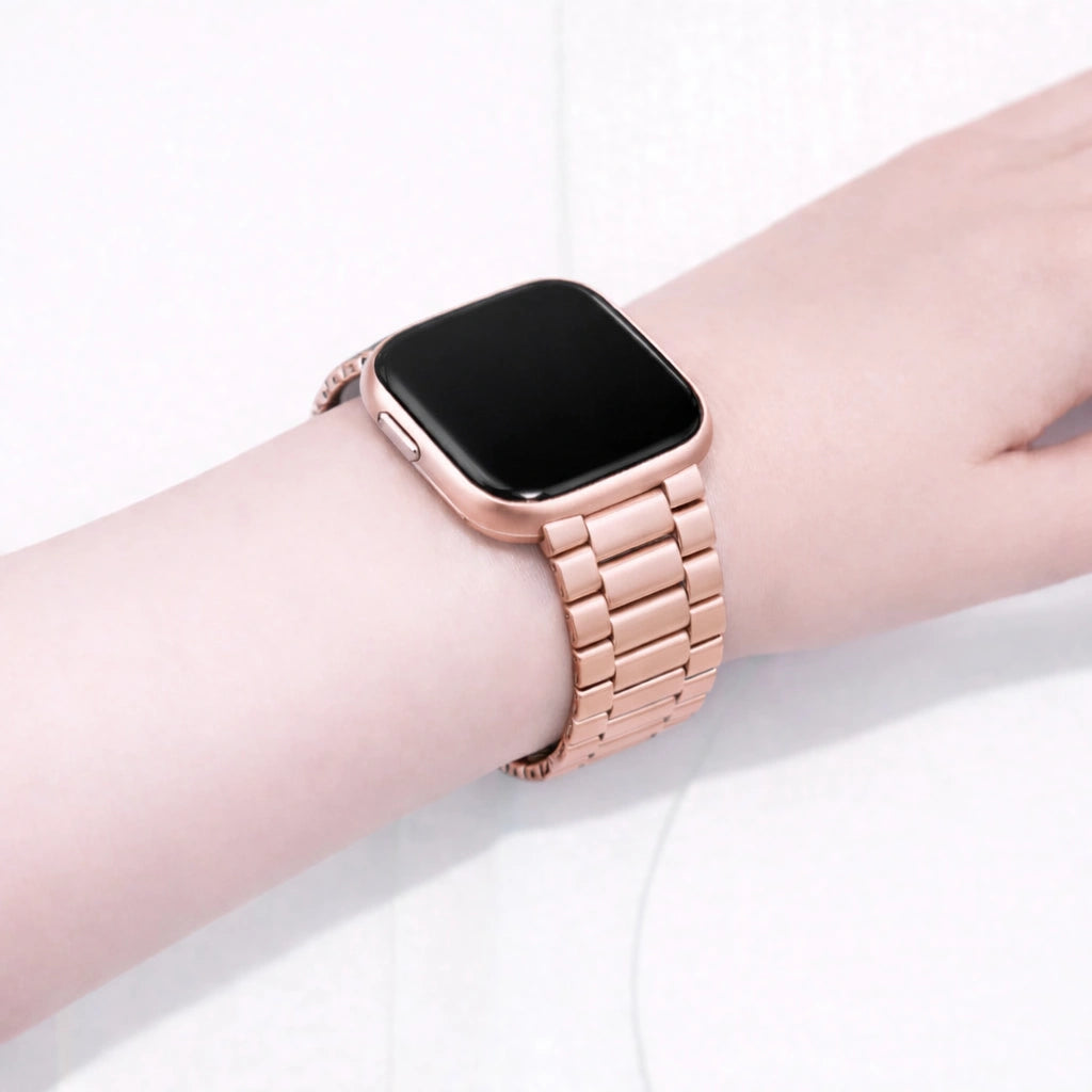 Rose gold metal strap fitted to a Fitbit Versa 2 on a wrist