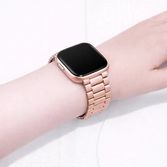 Rose gold metal strap fitted to a Fitbit Versa 2 on a wrist
