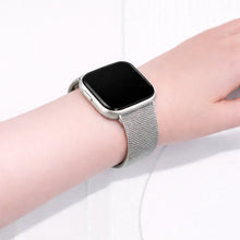 Silver metal band for Fitbit Versa 2 worn on the wrist with a smooth, adjustable mesh design