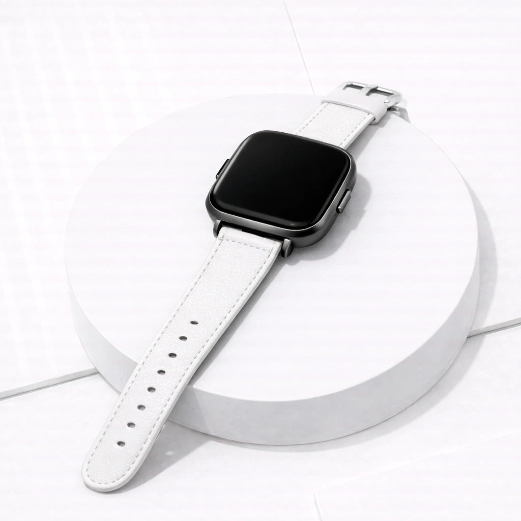 White leather watch strap for Fitbit Versa 2 displayed flat, showing stitching detail and stainless steel buckle.