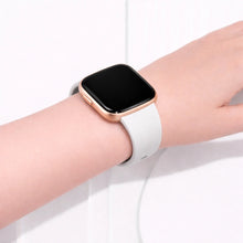 White Fitbit Versa 2 strap worn on the wrist, showing a comfortable silicone fit for everyday wear