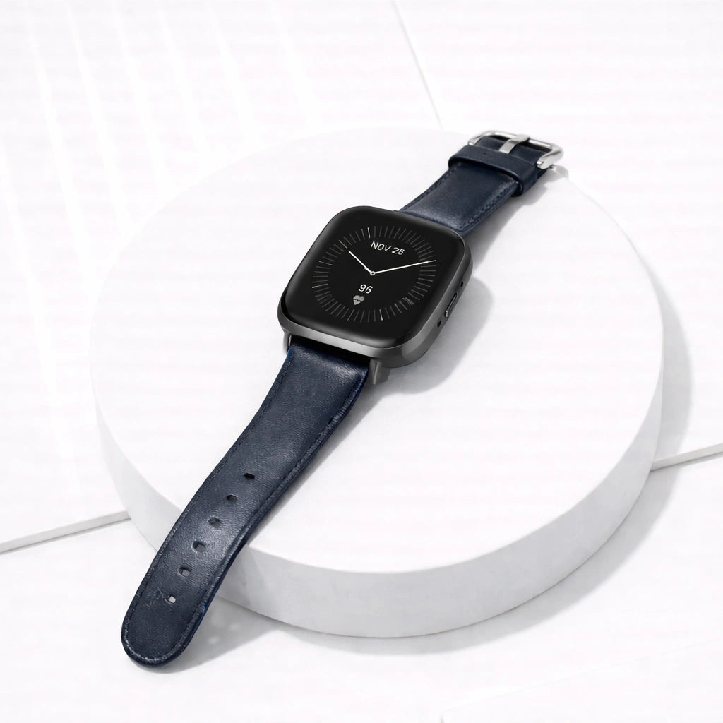 Navy leather strap for Fitbit Versa 3 displayed flat, featuring a stainless steel buckle and adjustable sizing holes.