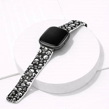 Skull print silicone watch strap for Fitbit Versa 4 displayed on a white background