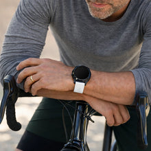 White Garmin Fenix 7 band worn while cycling with breathable and flexible fit
