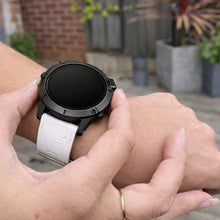 White strap for Garmin Fenix 7 showing adjustable fit and durable silicone material