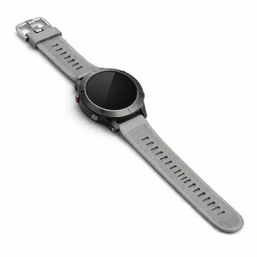 A grey Garmin Instinct band fitted to a rugged black round watch, shown laid flat