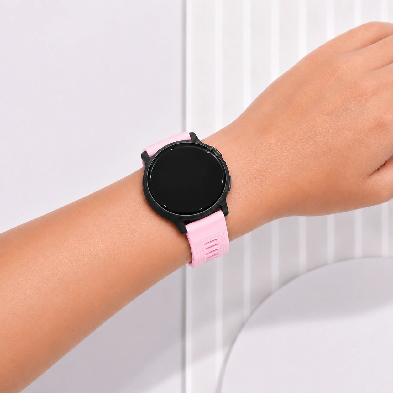 Light pink Garmin Venu 3S strap fitted to a smartwatch and worn on the wrist.