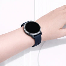 Garmin Venu fitness watch worn with a navy silicone sport band