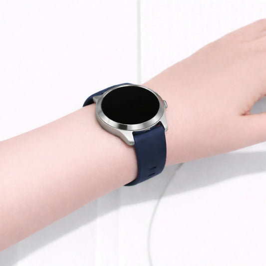 Garmin Vivoactive 4S smartwatch worn on the wrist with a navy blue silicone watch strap and silver case